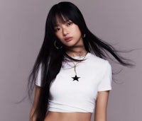 a young asian woman in a white crop top and black crop top