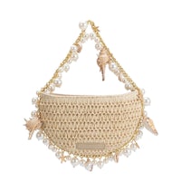 a rattan bag with shells and pearls